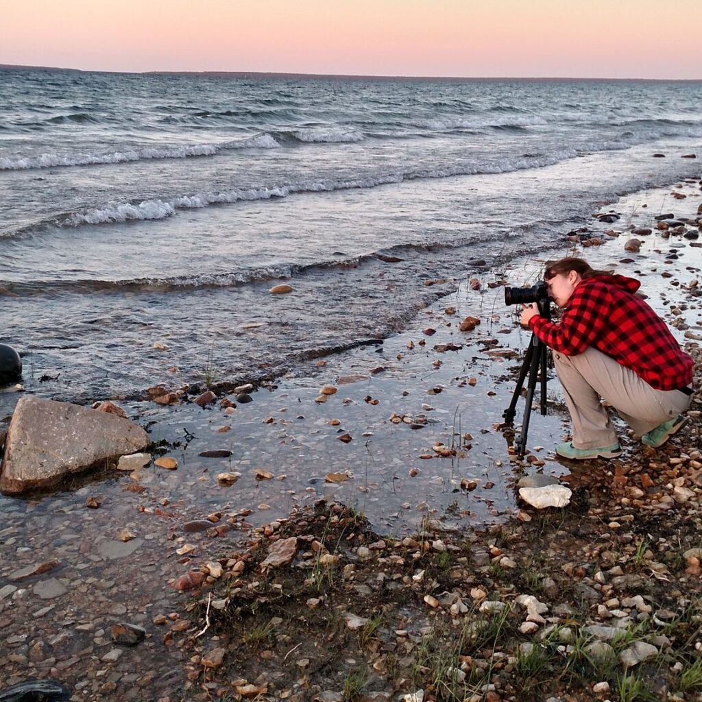 Amie on a beach taking photos of water